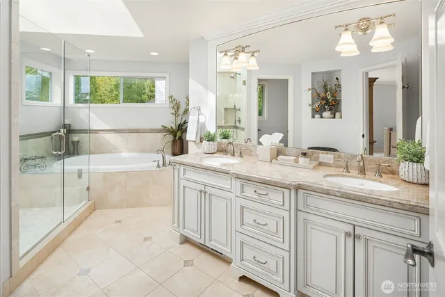 a spacious bathroom with a granite countertop sink a mirror and a shower
