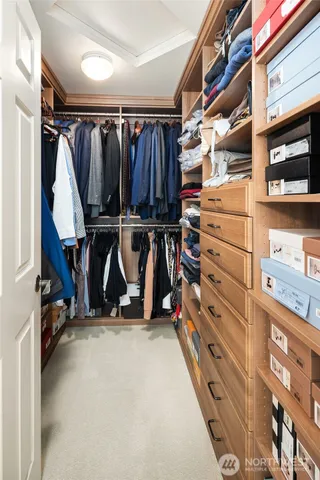 a view of walk in closet with clothes