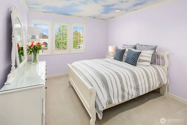 a bedroom with a bed and a potted plant