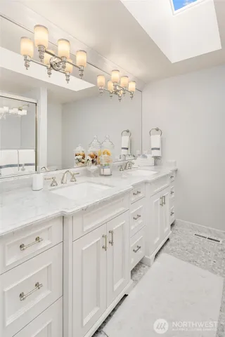 a bathroom with a double vanity sink and a mirror