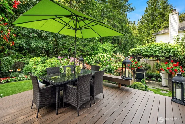 a view of a deck with furniture and a yard