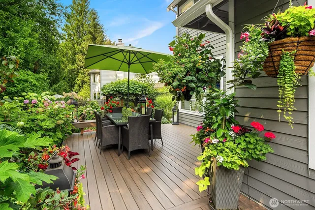 a view of a chair and table with potted plants