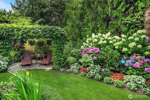 a view of a house with a backyard and garden