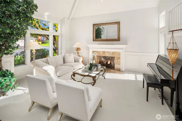 a living room with furniture a fireplace and a potted plant