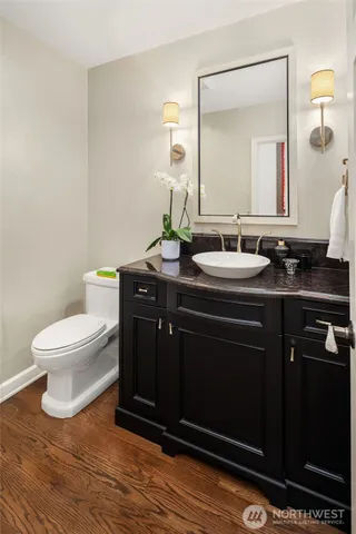 a bathroom with a toilet sink and mirror