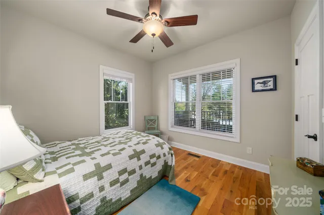 a bedroom with a bed dresser and a window