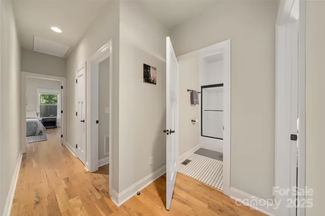 a view of a hallway with wooden floor and entryway