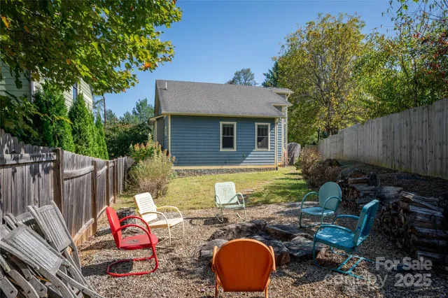 a backyard of a house with yard fountain and outdoor seating