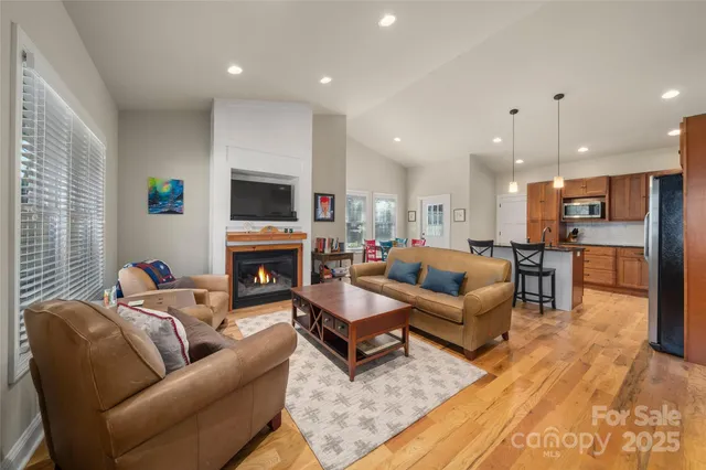 a living room with furniture a fireplace and a flat screen tv