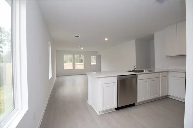 a kitchen with stainless steel appliances granite countertop a stove and a refrigerator