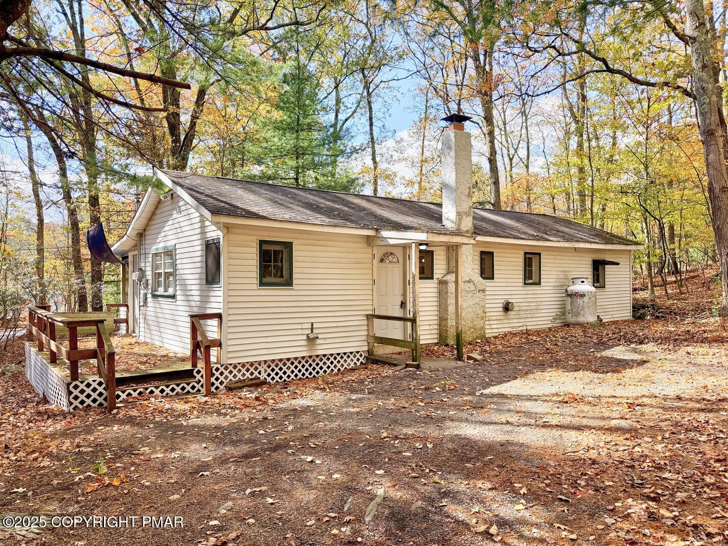 a view of a house with a yard covered in snow