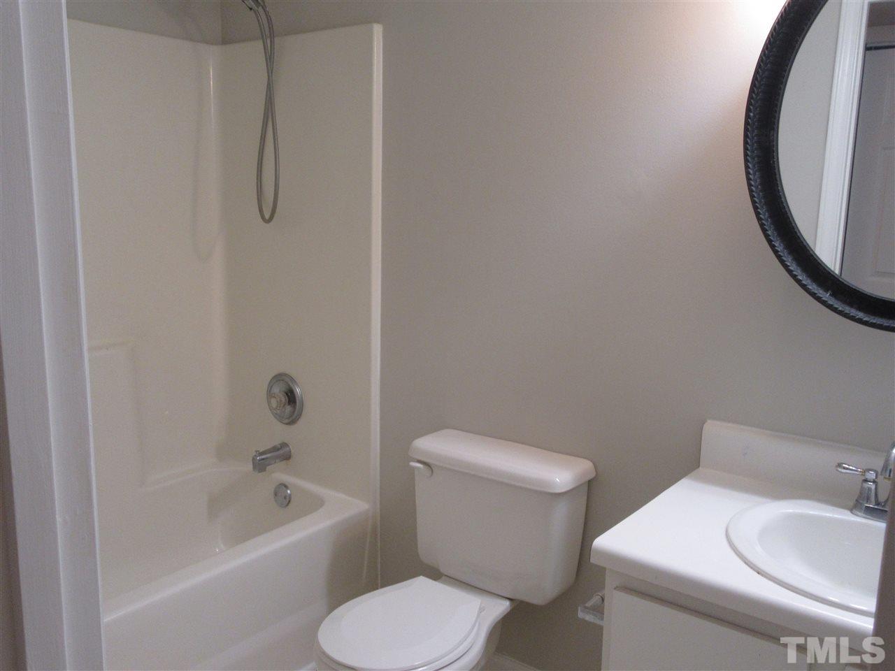5113 Silverdene Street Raleigh, NC 27616 - Photo 15 of 25 a white toilet sitting next to a bath tub
