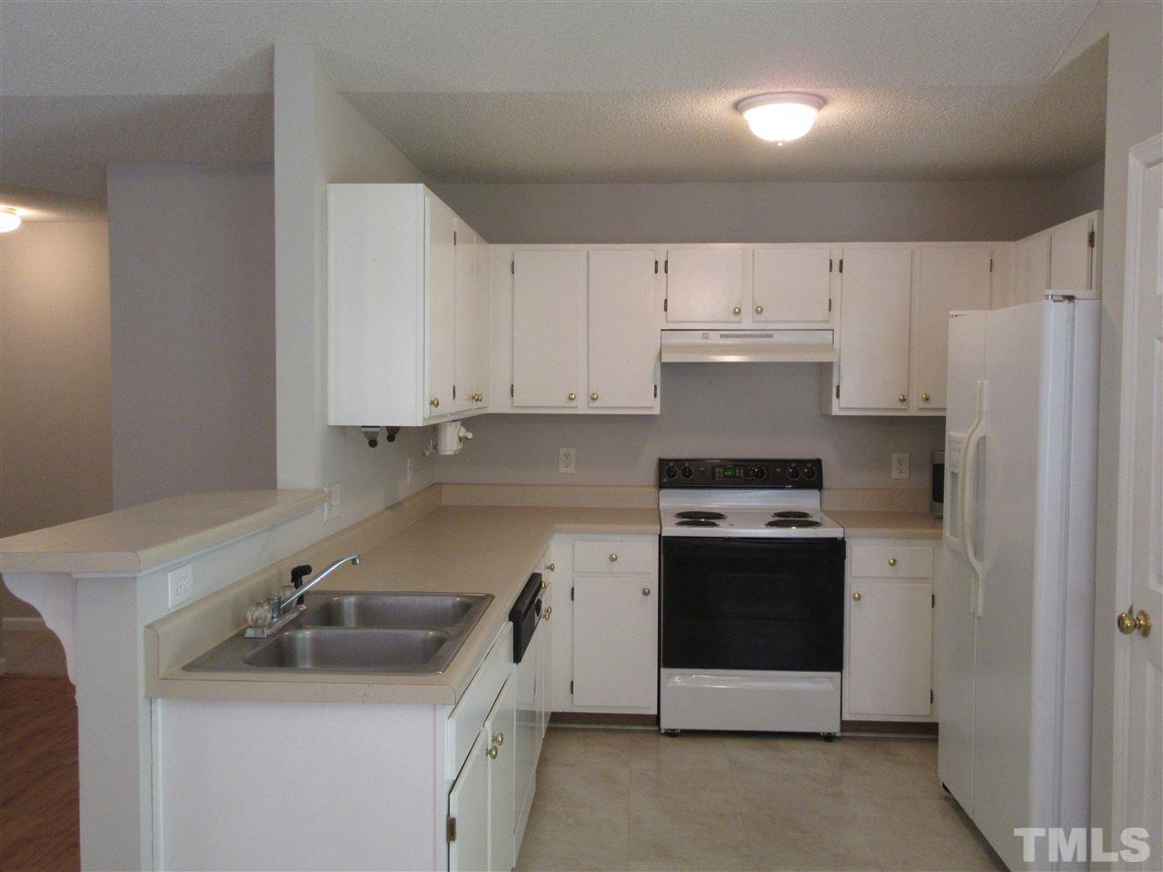 5113 Silverdene Street Raleigh, NC 27616 - Photo 19 of 25 a kitchen with a sink stove and refrigerator