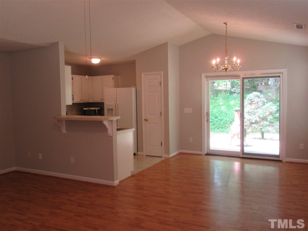 5113 Silverdene Street Raleigh, NC 27616 - Photo 3 of 25 a view of a kitchen with wooden floor and a window