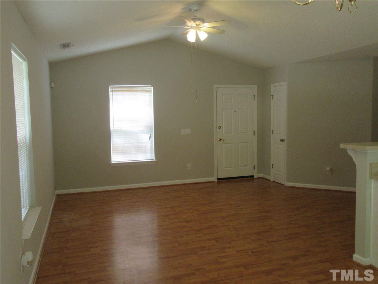 5113 Silverdene Street Raleigh, NC 27616 - Photo 5 of 25 a view of an empty room with wooden floor and a window