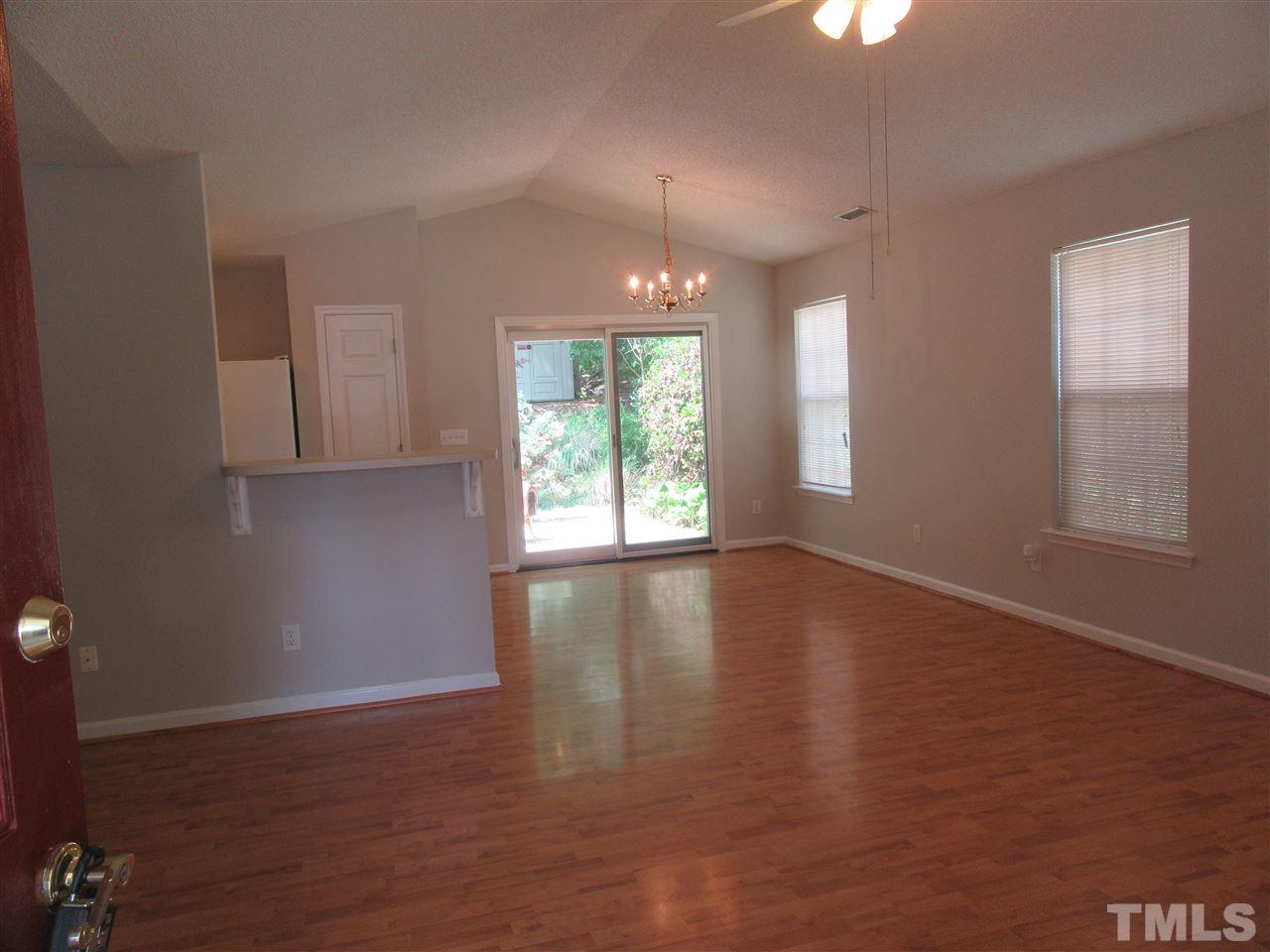 5113 Silverdene Street Raleigh, NC 27616 - Photo 7 of 25 an empty room with wooden floor and windows