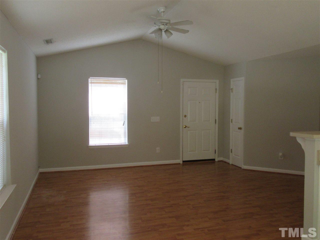 5113 Silverdene Street Raleigh, NC 27616 - Photo 8 of 25 an empty room with wooden floor and windows