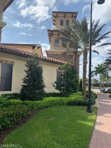 a view of a house with a garden and a pond