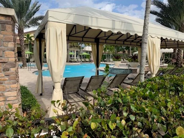 a patio with table and chairs and potted plants