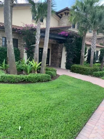 a front view of a house with a garden
