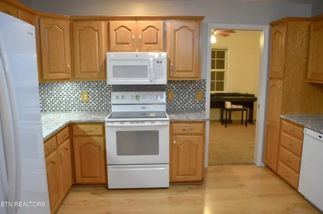 a kitchen with a refrigerator sink and cabinets