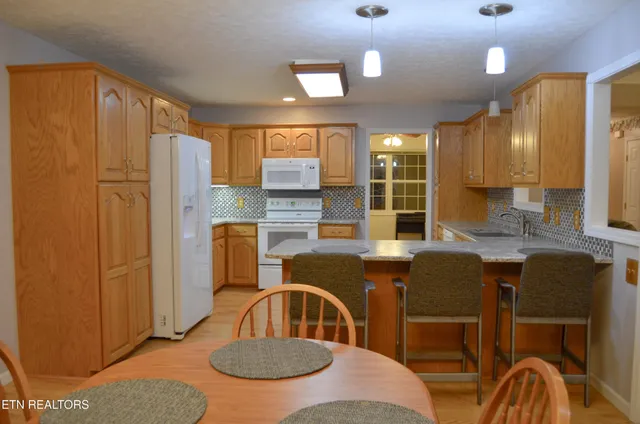 a view of a dining room with furniture and chandelier