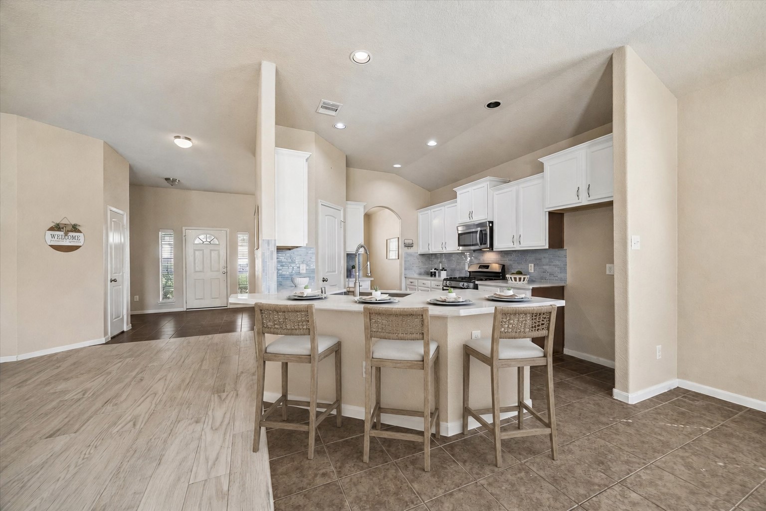 7806 Summer Night Lane Rosenberg, TX 77469 - Photo 11 of 23 A wide breakfast bar provides additional seating and counter space while overlooking the main living area and functional flow to the front entry. **This room has been virtually staged.