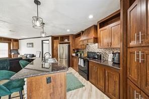 7466 County Road 573 Blue Ridge, TX 75424 - Photo 7 of 25 a kitchen with stainless steel appliances granite countertop sink stove top oven and cabinets