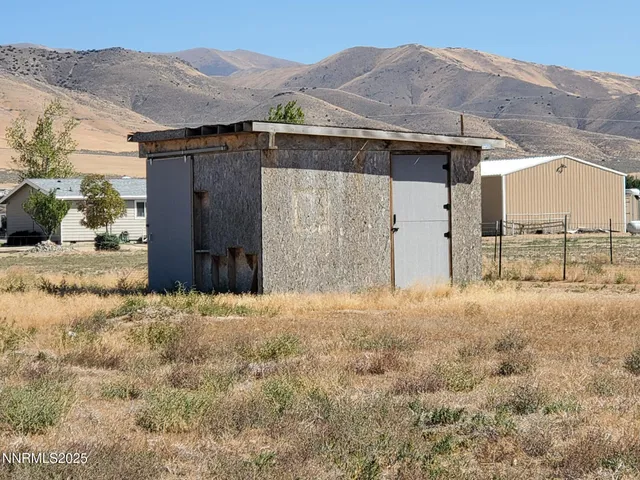 a view of a house with a yard and mountain