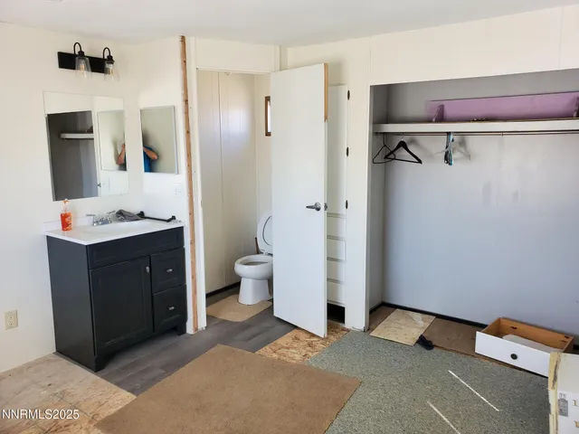 a spacious bathroom with a toilet sink and mirror