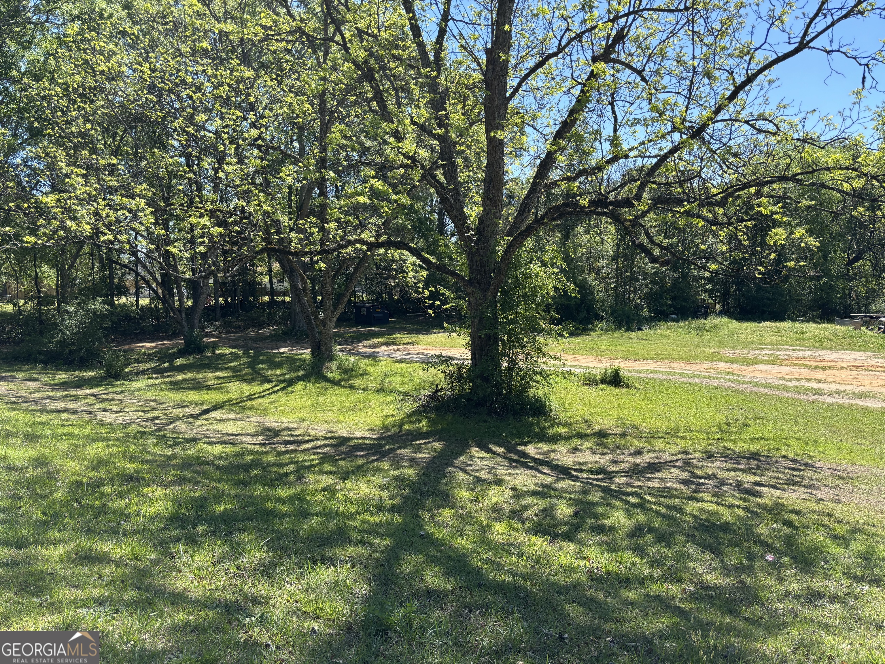 5250 Hightower Trail Oxford, GA 30054 - Photo 1 of 4 a view of a swimming pool with a yard and large trees