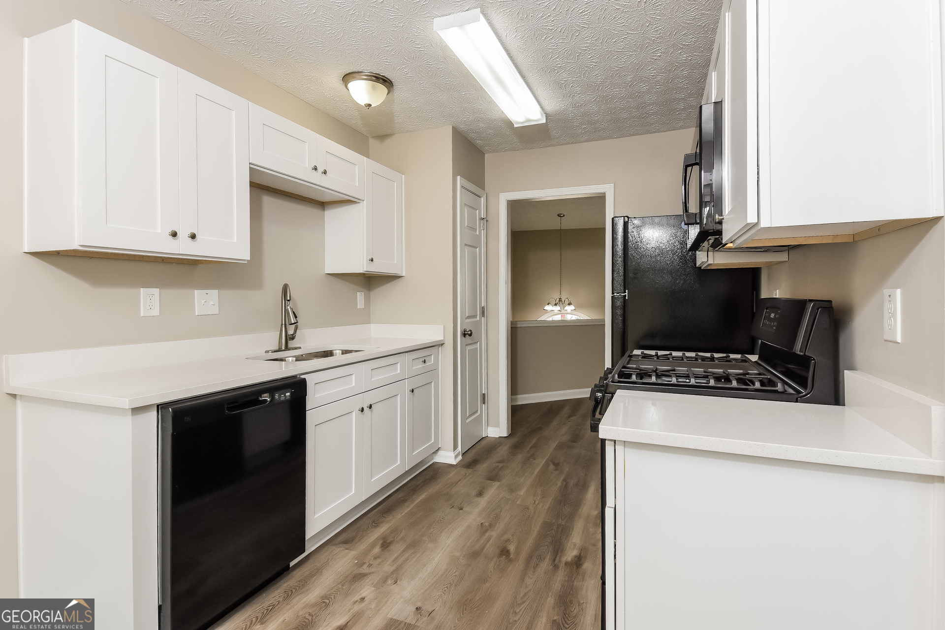 4809 Nature Trail Austell, GA 30106 - Photo 5 of 17 a kitchen with granite countertop a sink a stove and refrigerator