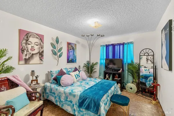 a bedroom with furniture and a chair
