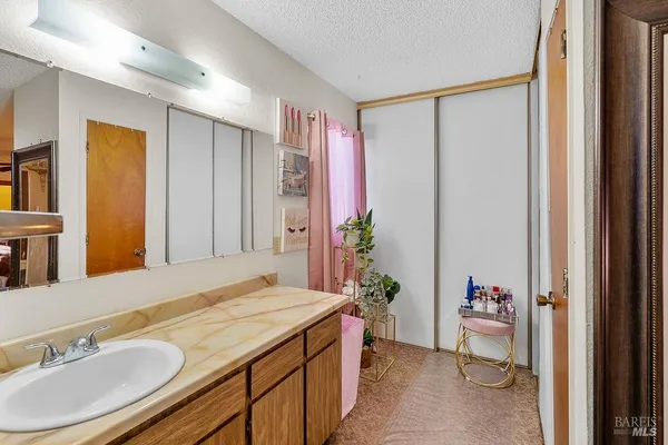 a bathroom with a granite countertop sink and a mirror