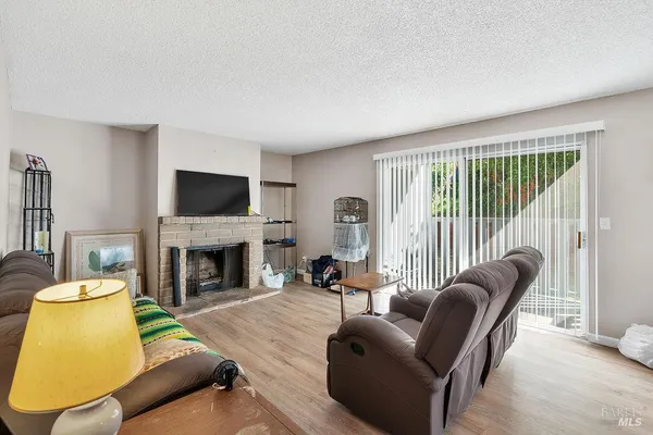 a living room with furniture a fireplace and a flat screen tv