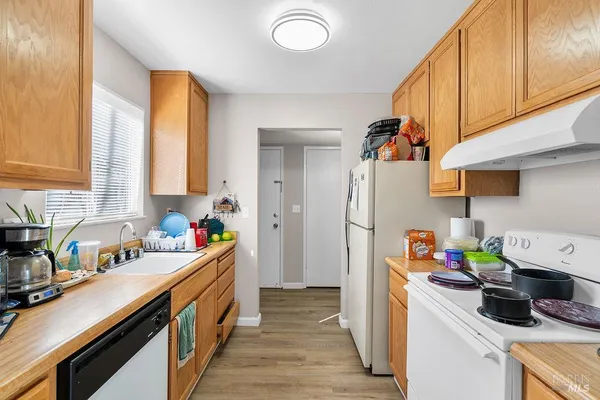 a kitchen with a sink stove and cabinets