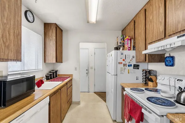 a kitchen with a sink stove and refrigerator