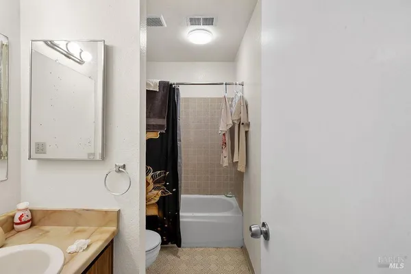 a bathroom with a tub sink and a mirror