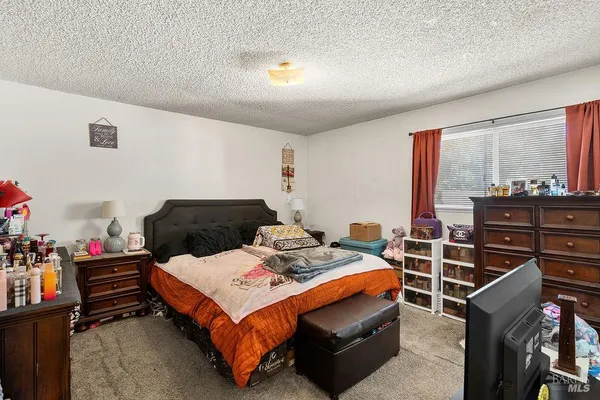 a bed room with a bed and a window
