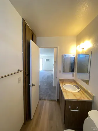 an empty room with closet and windows