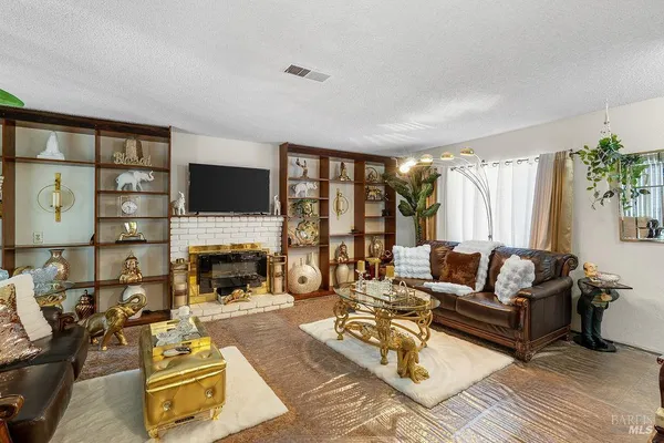a living room with furniture fireplace and a flat screen tv