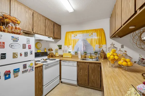 a kitchen with stainless steel appliances a stove a sink and cabinets