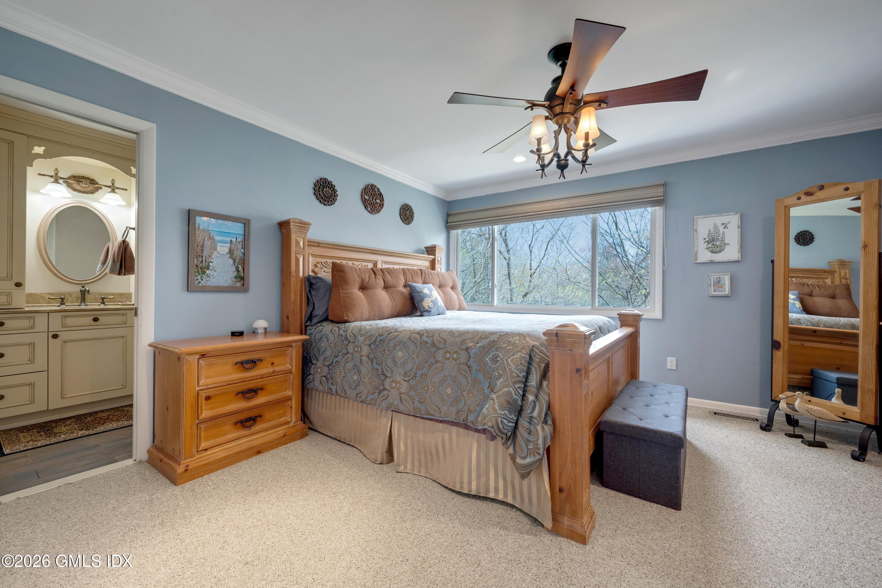 58 Stirrup Lane, Unit 58 Riverside, CT 06878 - Photo 8 of 23 a bedroom with a bed and a chandelier