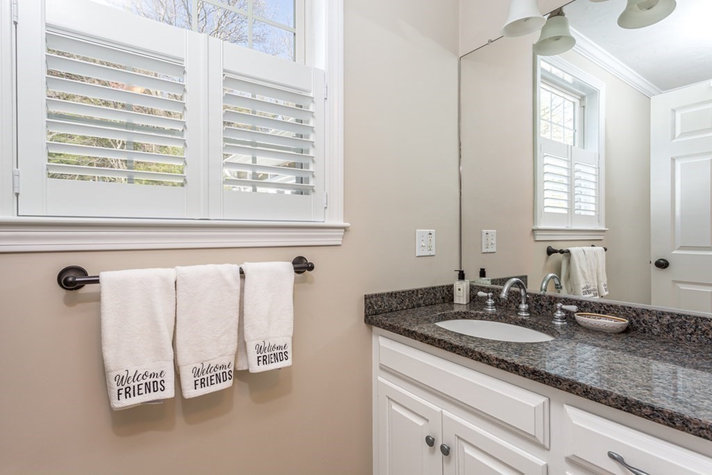 4 Griffin Road Franklin, MA 02038 - Photo 12 of 42 a bathroom with a granite countertop sink and a window