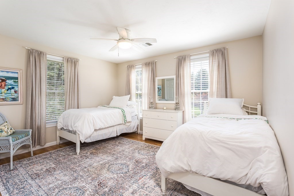 4 Griffin Road Franklin, MA 02038 - Photo 29 of 42 a bedroom with a large bed and a chandelier