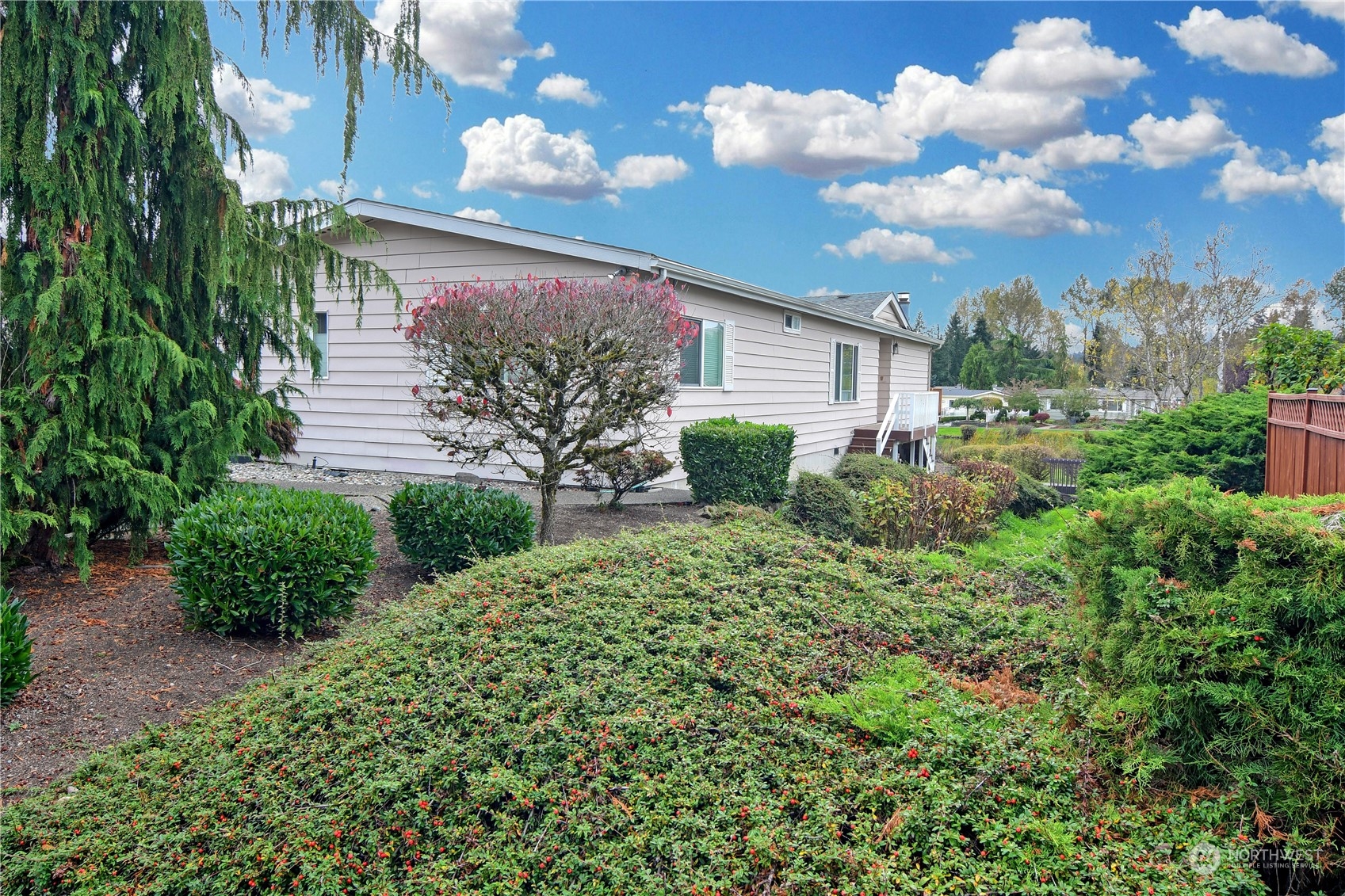 23716 Lake Drive East Bothell, WA 98021 - Photo 3 of 28 a view of a house with a big yard and large trees