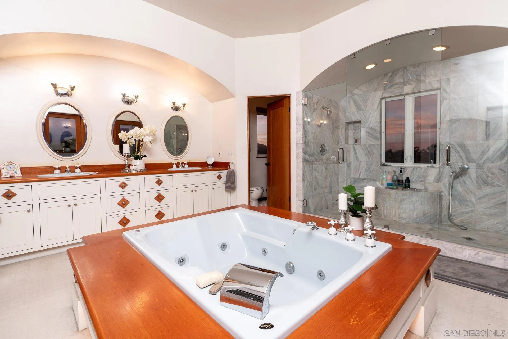 553 Rimrock Road El Cajon, CA 92020 - Photo 32 of 43 a bath tub sitting next to a bathroom sink and a mirror