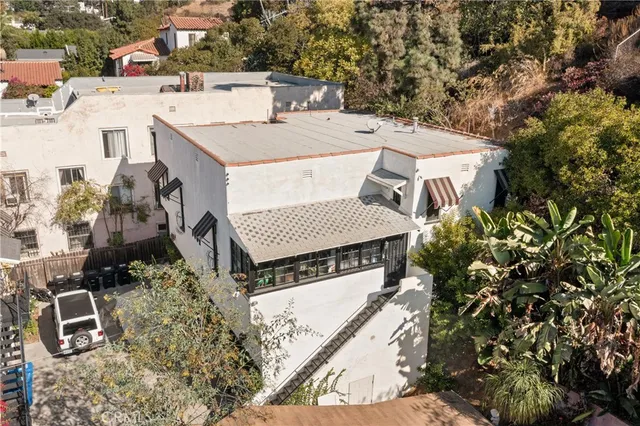 an aerial view of a house with yard and parking space