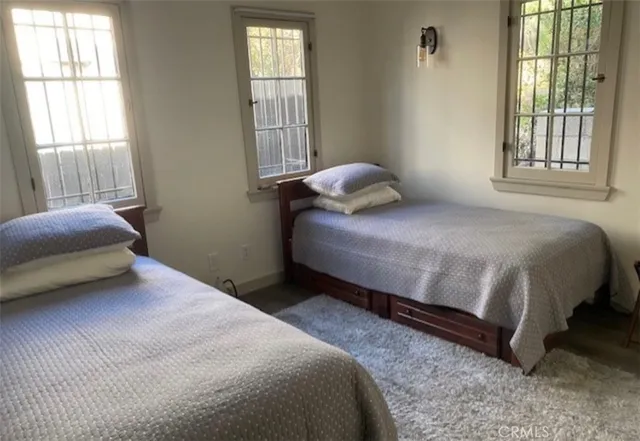 a bedroom with a bed and flat screen tv