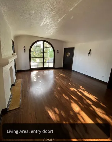 a view of an entryway with wooden floor